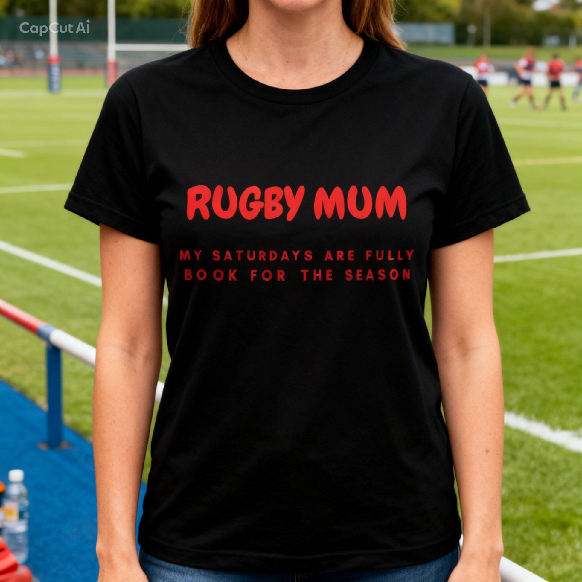 Person wearing a black t-shirt with red text on a rugby field